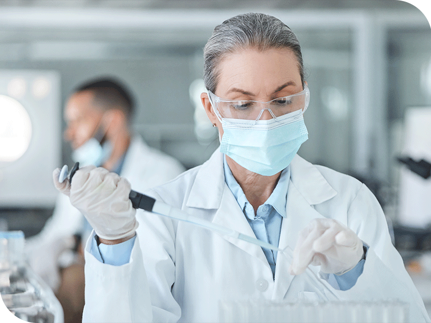 A scientist using a dropper and test tube.